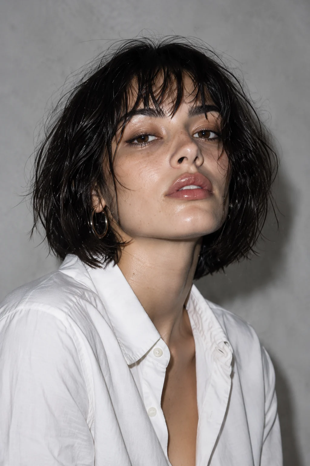 Direct-flash editorial portrait with a short black bob and white shirt